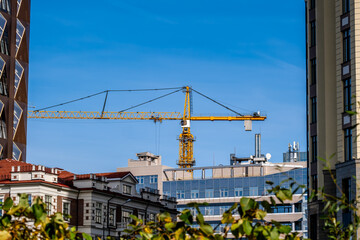 Naklejka premium A tower crane under construction against the sky.