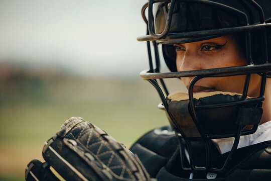 Professional baseball catcher in protective gear intensely focused during a game