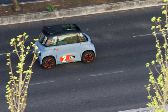 Citroen ami electric car driving on a road in the city