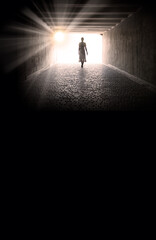 A woman emerges from a tunnel into the light