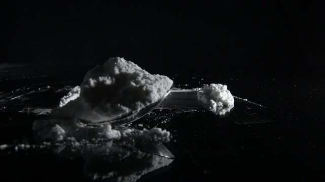 Powder of cocaine in a spoon on a crystal