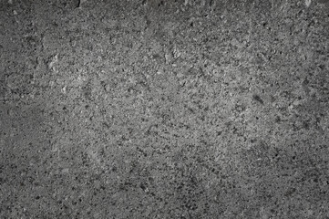 The photo shows a close-up of a grey concrete wall