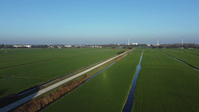 Bicycle path route Zoeterwoude, lush green grass, wind industry location