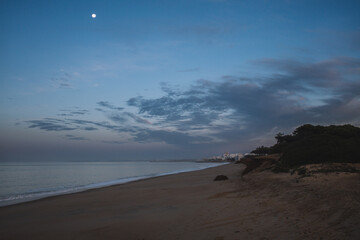the moon over the sea, sunrise on the beach