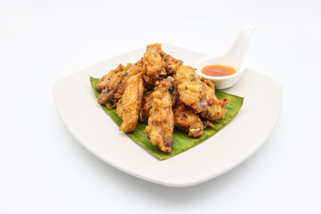 Fried chicken on white plate with white background, asia food, unhealthy food