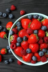 Different fresh ripe berries in bowl 