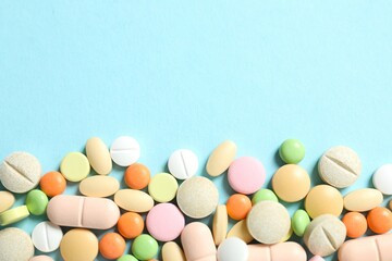 Various medicine pills on color background
