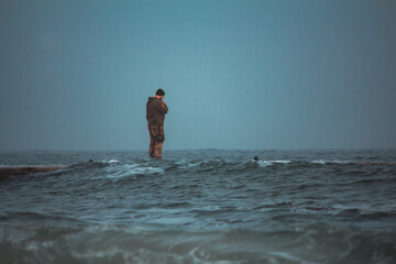 Soldier on Pier in Stormy, Foggy Weather