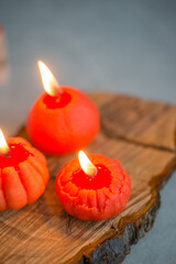 Small bright orange candles in the shape of a tangerine
