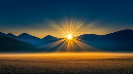 A vibrant sunrise over a misty field with silhouetted mountains in the background.