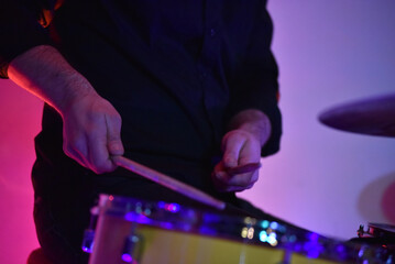 Drummer playing live on stage at blues concert