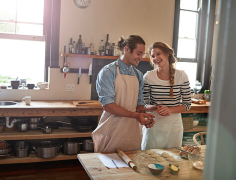 Kitchen, baking and couple with dough, house and preparation of cookies, learning and ingredients. Bonding, teaching and people with skill for snack, romance and biscuits in home and eggs for recipe
