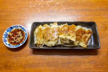 Japanese dumpling or Gyoza on the white plate with soy sauce