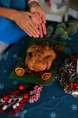 the moment of decorating a beautifully roasted turkey on a festive Christmas Eve table.The turkey, golden and succulent, serves as the centerpiece among an array of seasonal dishes and decorations.