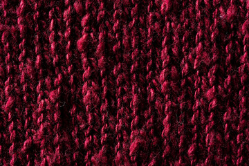 Close-up macro texture of a knitted burgundy sweater