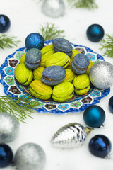 Christmas or New Year green and blue homemade cookies called Nuts stuffed with condensed milk and walnuts surrounded with Christmas balls 