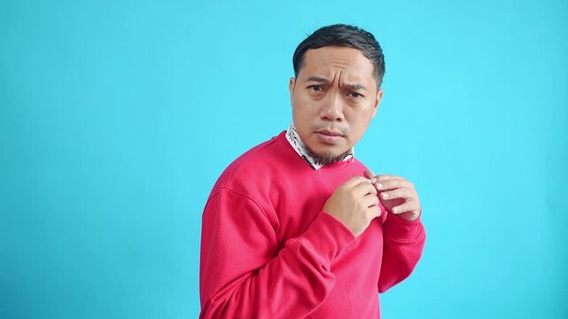 Young Asian Man Showing Shocked Expression And Scared Isolated Blue Light Studio Background
