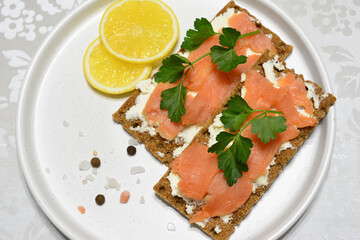 healthy snack with crisp bread, cottage cheese and smoked salmon top view
