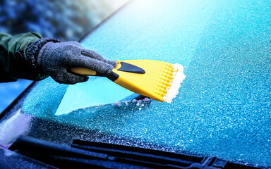 Clearing and remove snow from windshield, Scraping ice. Winter season car window cleaning. Copy space for your text. Panoramatic banner.