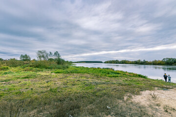 A couple of people are fishing in a river