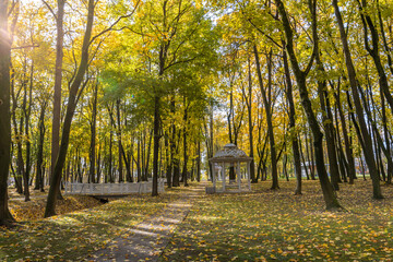 A park with a white gazebo and a bridge