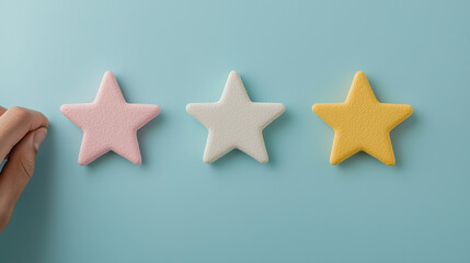 Hand placing colorful star shapes on a blue background, perfect for creative projects and artistic themes, customer feedback by topics focus on sentiment analysis
