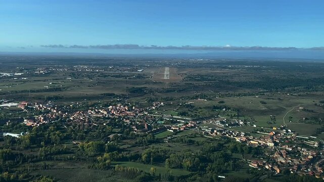 Immersive real tima approach to an isolated airport in a rural landscape in central Spain, as seen by the pilots of a jet from the cockpit.