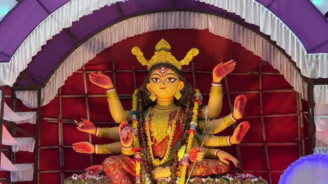 Peaceful look of Devi Durga idol illuminate with yellow light during dusk at Red Road for carnival procession in Kolkata, India.