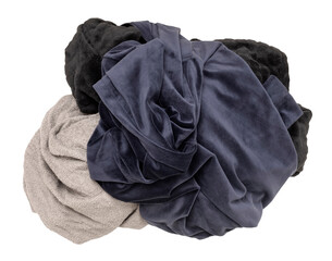 Pile of various crumpled clothes, soft fabrics in dark colors like navy, gray, and black, on...