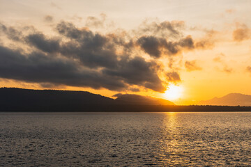 Beautiful Blazing Sunrise and golden sky landscape over the Sea.