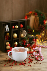 Christmas and new year holidays background. Christmas decorations, candy canes and hot cocoa cup on wooden table. symbol of festive winter season. magic fairy tale, cozy home atmosphere