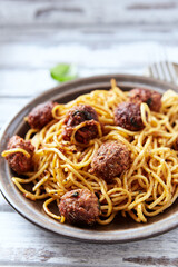 Spaghetti Pasta with Meatballs and fresh Basil o bright background. Close up.