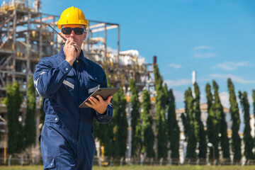 Petroleum industry engineer worker working outdoor. Refinery oil and gas service foreman operate...