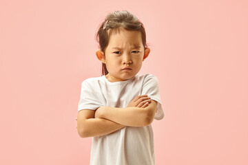 Studio portrait, Little Girl Expressed Sad, Displeased or Dissatisfied Crossing her Folded Arms...