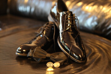 Close-up of Groom's Accessories: Black Leather Shoes, Bow Tie and Cufflinks