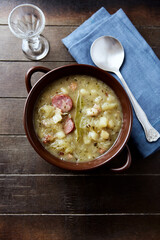 Cabbage soup on wooden background. Top view