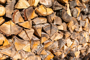 pile of stacked dry firewood for winter fireplace use. Textured background