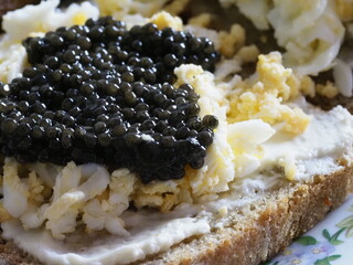 Open Sandwich with Black Caviar and Egg on Homemade Bread