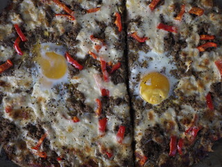 Delicious Pizza with Eggs and Meat on Wooden Table