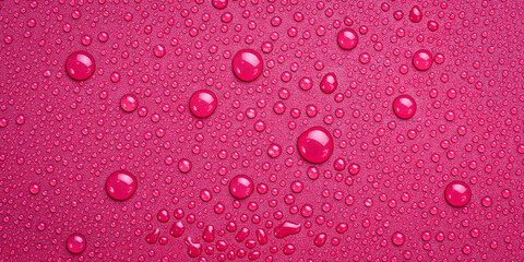 Close-up of water drops on a purple background. Macro photo. Top view.