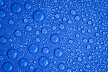 Close up of water droplets on blue background. Macro photo. Top view.