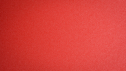 Fototapeta premium Red textured background, free space for text or design. Top view.