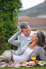 Love, mature couple and picnic with juice for nutrition, food and bonding together with connection. Happy people, man and woman with beverage for drinking, care and commitment in marriage in backyard