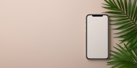 Smartphone on a light background with tropical leaf decoration.