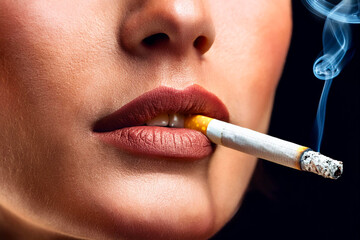Naklejka premium smoking woman with a cigarette. studio shot
