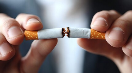 Person breaking cigarette in half, hands holding burning cigarette, symbol of quitting smoking, health and wellness, anti-smoking, overcoming addiction, quitting habit, fire and smoke