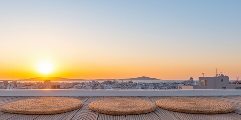 Obraz premium Sunset view from a rooftop terrace overlooking a city skyline.