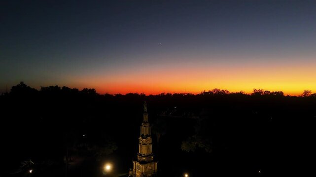 Aerial rise at sunset over the Civil War memorial in Forsyth Park, Savannah, GA. A beautiful, serene scene blending historical significance with the warm glow of dusk.