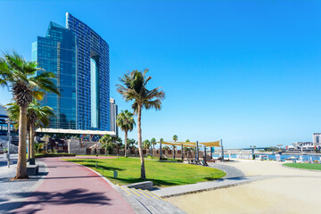 Dubai jumeirah beach with hotels, sea, sand, palms and blue sky. JBR beach in Dubai, UAE.