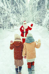 Santa Claus with a bag of gifts and children in a snowy forest.